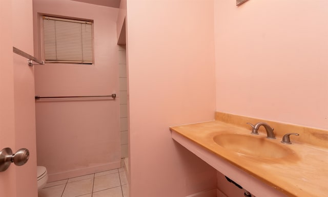 bathroom featuring tile patterned floors, toilet, and sink