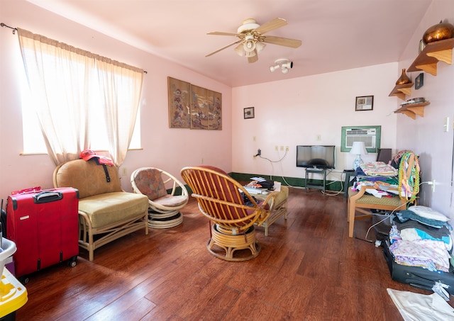 living room featuring a wall mounted AC, ceiling fan, and dark hardwood / wood-style flooring