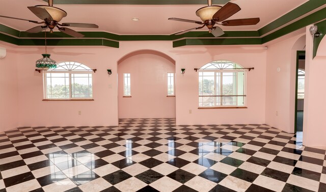 unfurnished room with a wealth of natural light, crown molding, and ceiling fan