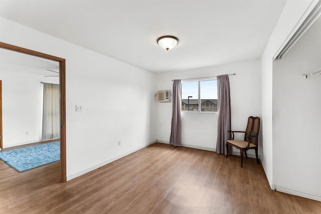 spare room with hardwood / wood-style floors and a wall mounted AC