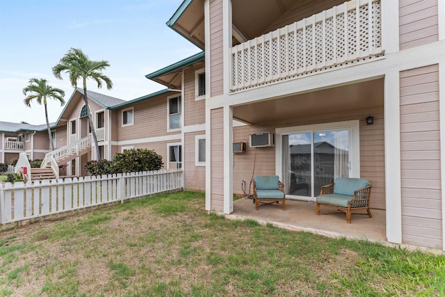 rear view of property with a lawn and a patio