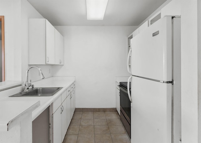 kitchen featuring sink, white cabinetry, stainless steel range with electric stovetop, light tile patterned floors, and white fridge