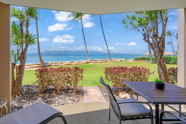 view of patio / terrace with a water view and outdoor dining area