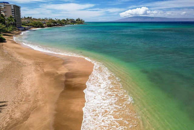 water view featuring local beach and a mountainous background