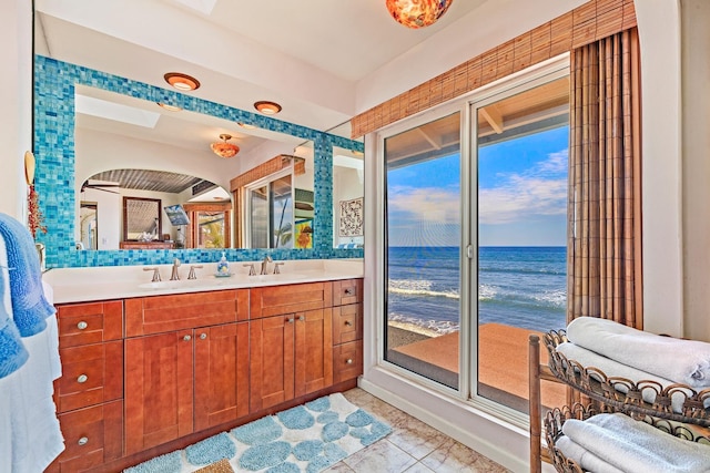 full bath featuring a water view and vanity