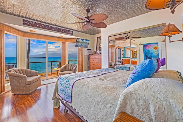 bedroom featuring an ornate ceiling, a ceiling fan, access to outside, and hardwood / wood-style floors