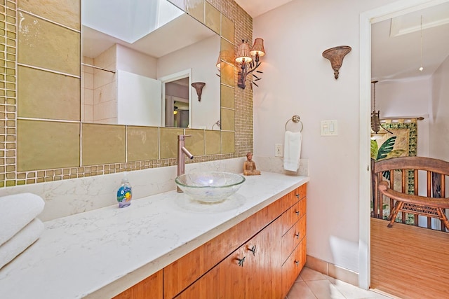 bathroom with tasteful backsplash, vanity, and tile patterned floors