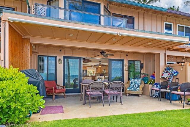 view of patio with a balcony, a grill, and ceiling fan