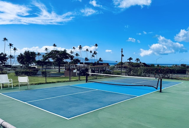 view of sport court featuring fence