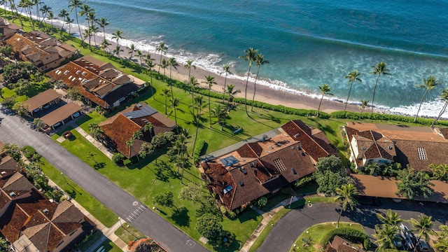 birds eye view of property with a water view, a residential view, and a beach view