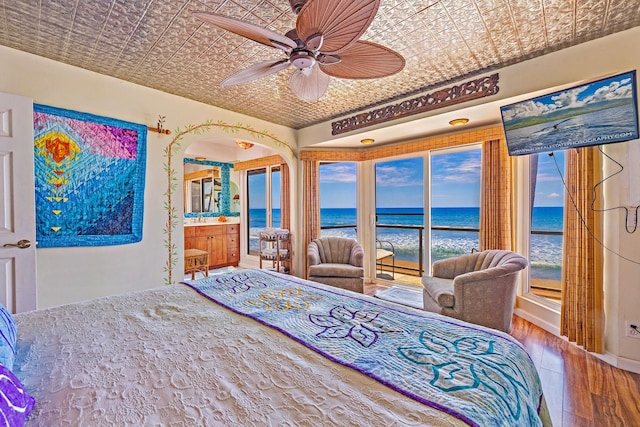 bedroom with access to outside, hardwood / wood-style floors, an ornate ceiling, and a ceiling fan