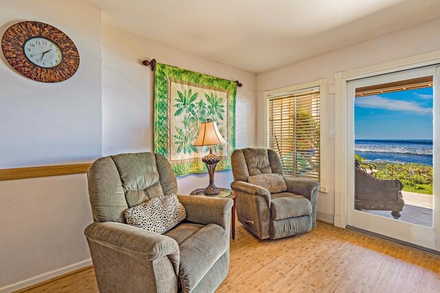 sitting room featuring baseboards and light wood-style floors