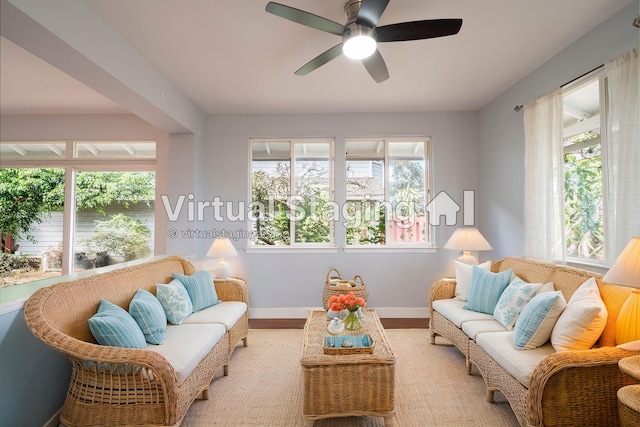 sunroom featuring plenty of natural light and a ceiling fan