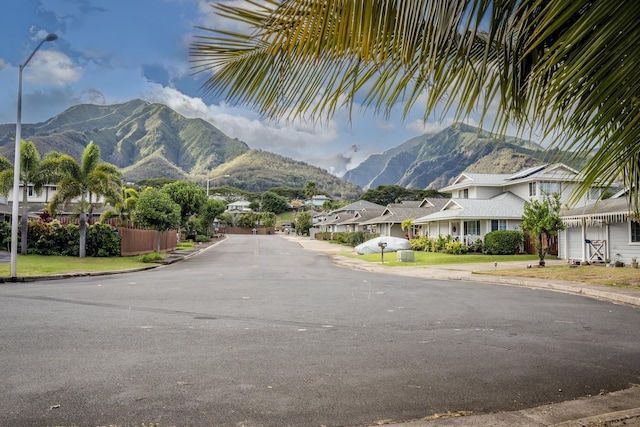 view of road featuring street lighting, a residential view, and a mountain view