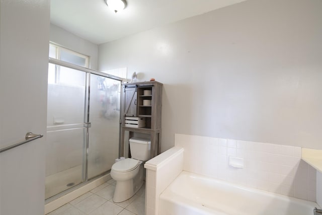 full bathroom with a garden tub, a shower stall, toilet, and tile patterned floors