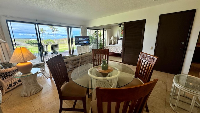 tiled dining area with plenty of natural light, a textured ceiling, and ceiling fan