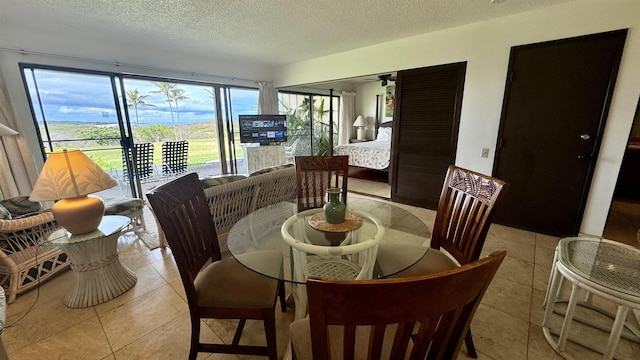 dining space with light tile patterned floors and a textured ceiling