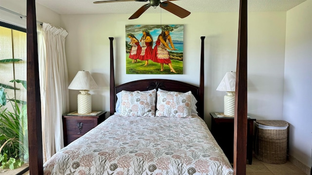 tiled bedroom featuring a textured ceiling and ceiling fan