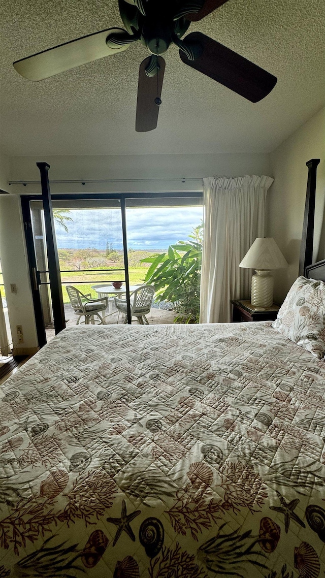 bedroom with access to outside, ceiling fan, and a textured ceiling