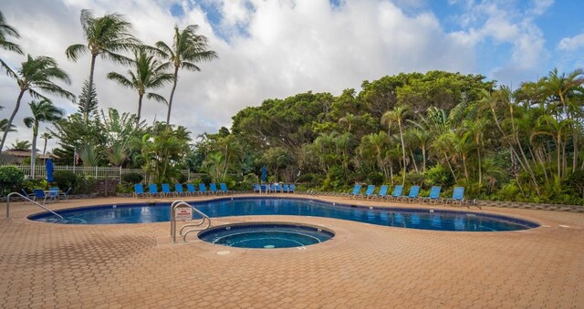 view of pool featuring a patio area and a hot tub