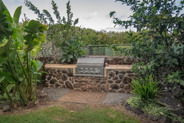 view of patio with fence, an outdoor kitchen, and area for grilling