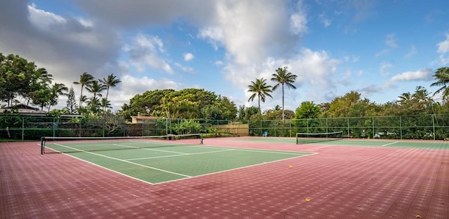 view of tennis court with community basketball court and fence