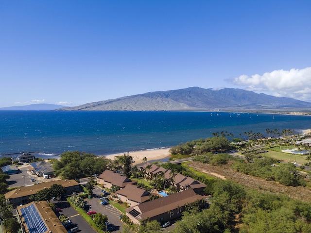 aerial view featuring a water and mountain view and a view of the beach