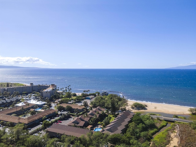 drone / aerial view featuring a water view and a view of the beach