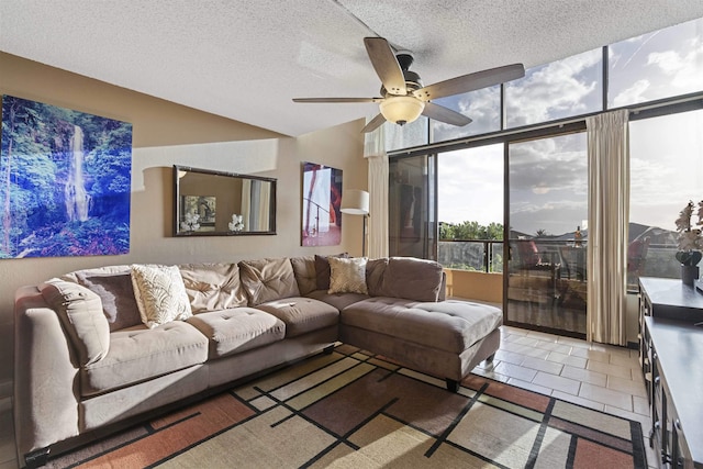 living room with tile patterned flooring, a ceiling fan, and a textured ceiling