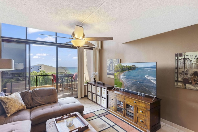 living room with tile patterned flooring, a textured ceiling, and ceiling fan