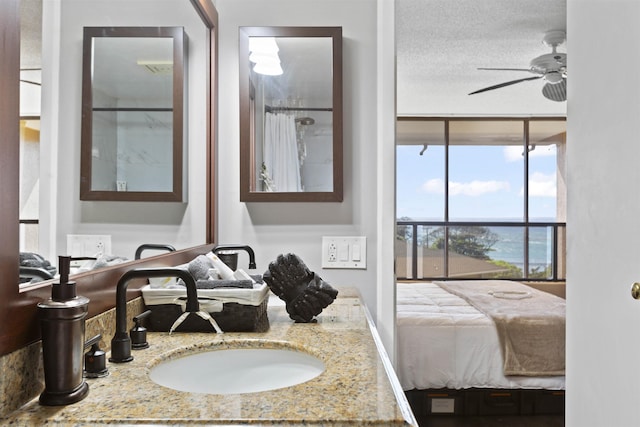 full bath featuring vanity, ceiling fan, and expansive windows