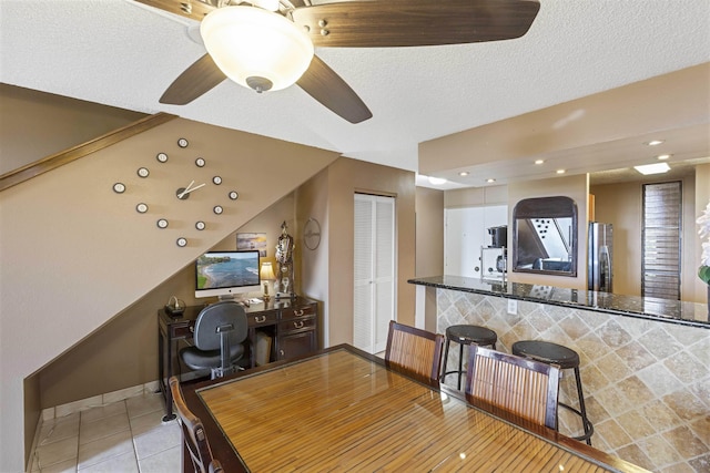 office space with light tile patterned floors, baseboards, recessed lighting, ceiling fan, and a textured ceiling