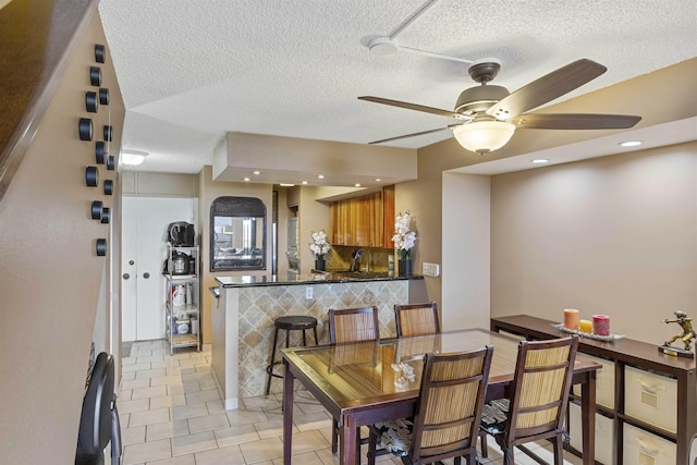 dining area with light tile patterned floors, a ceiling fan, recessed lighting, and a textured ceiling