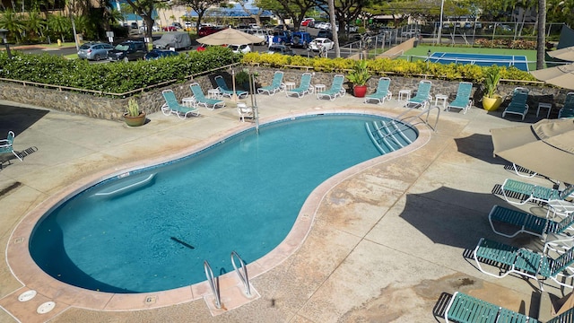 community pool featuring a patio area and fence