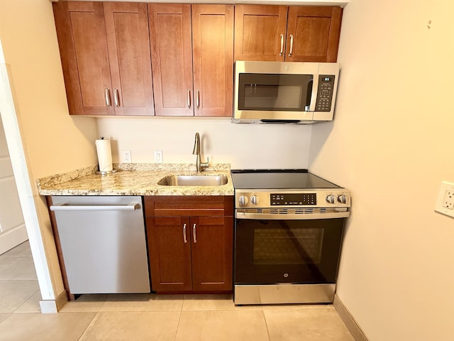 475 Front St Unit 308, Lahaina, HI 96761 - kitchen with appliances with stainless steel finishes, a sink, light tile patterned floors, and light stone counters