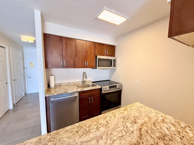 475 Front St Unit 308, Lahaina, HI 96761 - kitchen featuring appliances with stainless steel finishes, a sink, light stone countertops, and tile patterned floors