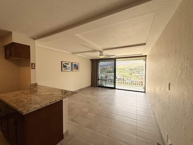 475 Front St Unit 308, Lahaina, HI 96761 - spare room with a textured wall, a textured ceiling, tile patterned floors, a ceiling fan, and baseboards