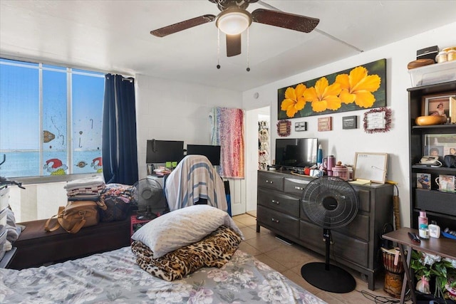 bedroom with ceiling fan and light tile patterned flooring