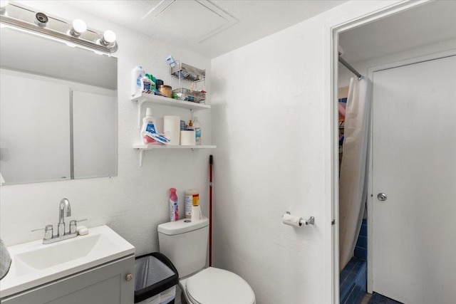 bathroom featuring toilet, vanity, and a shower with shower curtain