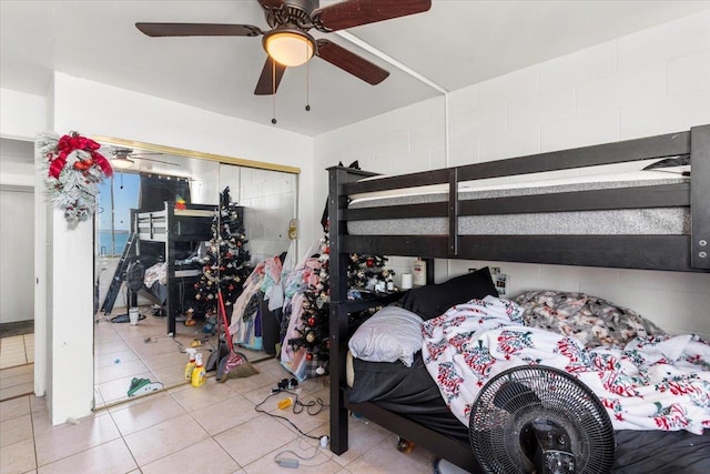 tiled bedroom featuring ceiling fan