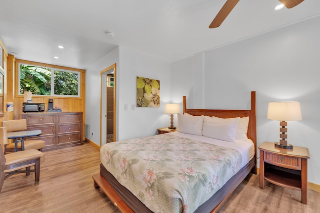 bedroom with ceiling fan and light hardwood / wood-style floors