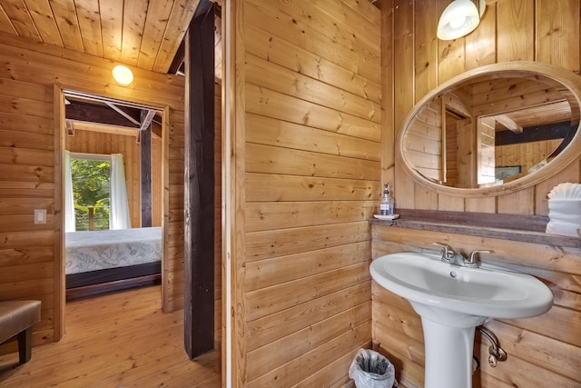 bathroom with wooden ceiling, wood-type flooring, and wood walls