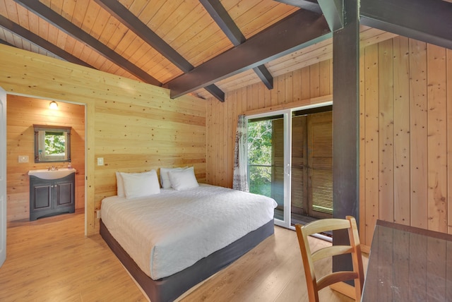 bedroom featuring sink, wooden walls, wood ceiling, and light wood-type flooring