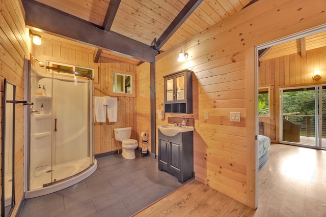 bathroom featuring wood walls, vanity, a shower with door, beamed ceiling, and hardwood / wood-style floors