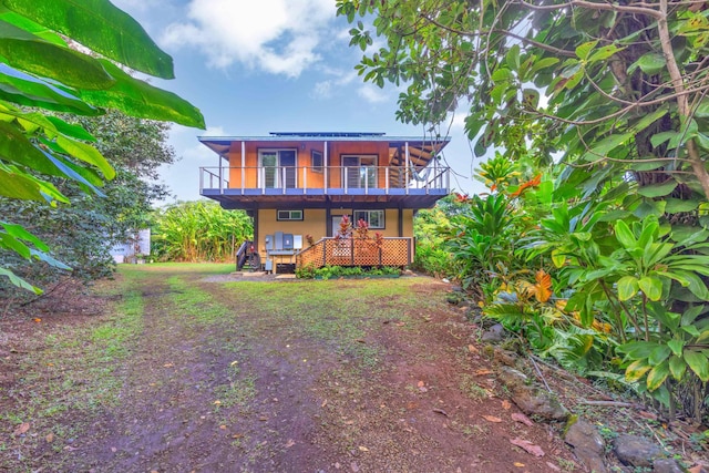 rear view of house featuring a deck