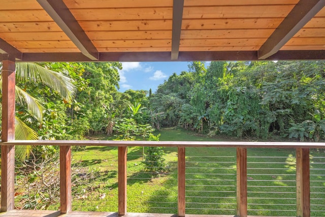 wooden terrace featuring a lawn