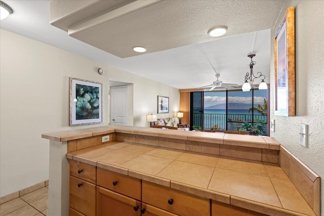 4327 Lower Honoapiilani Rd Unit 802, Lahaina, HI 96761 - bathroom featuring a ceiling fan, tile patterned floors, and a textured ceiling