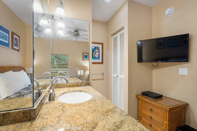 bathroom with ceiling fan and vanity