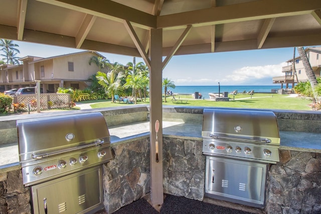 view of patio / terrace featuring a gazebo, a water view, area for grilling, and grilling area