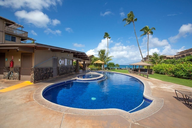 view of pool with a gazebo and a water view